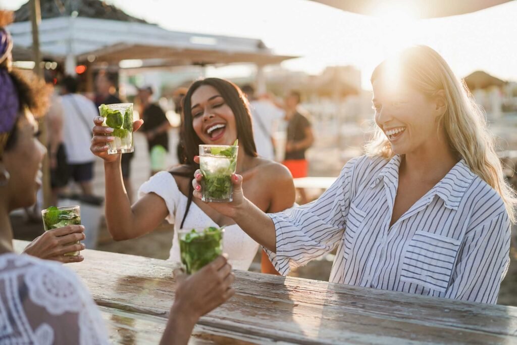 happy-girls-having-fun-cheering-with-cocktails-at-5V9ZUL7.jpg